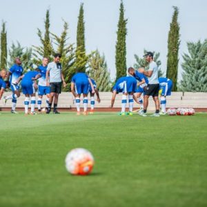 Stretching is important at the intensive soccer camp in Valencia.